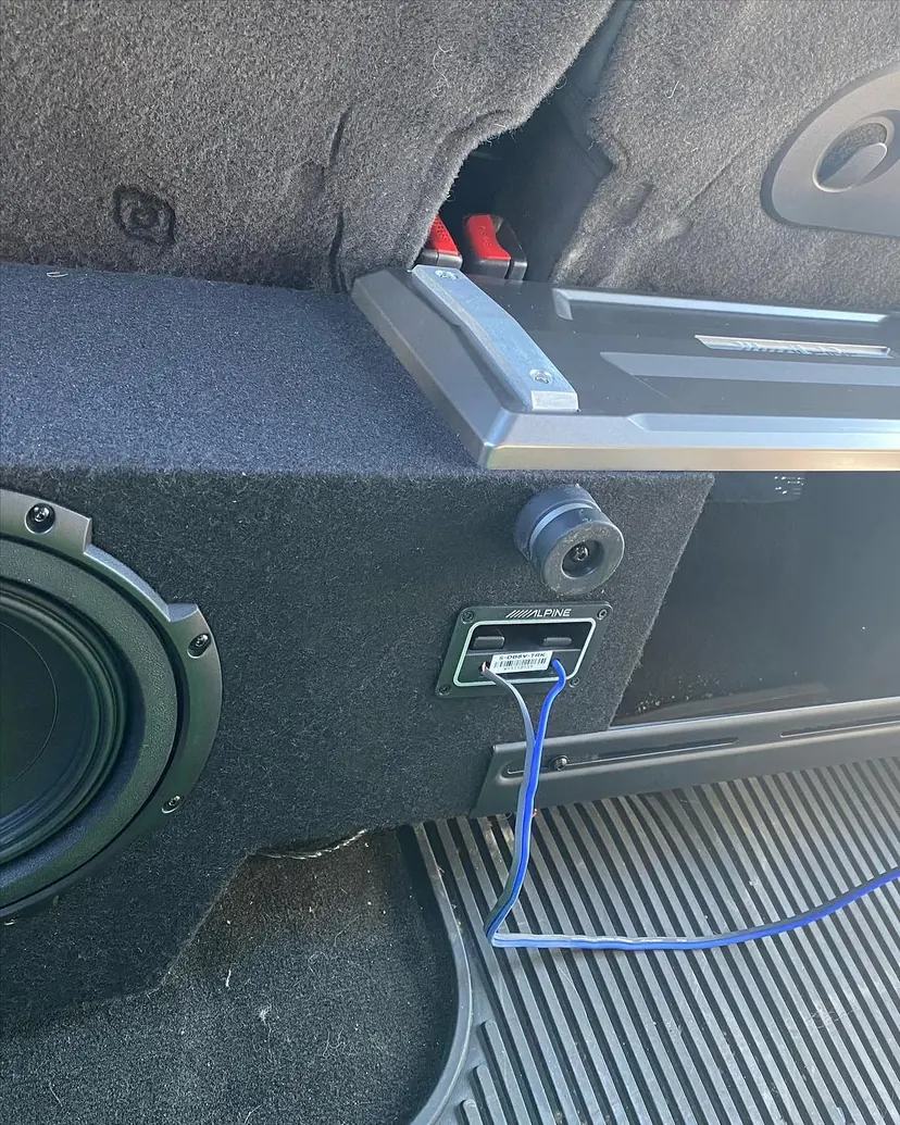 Alpine vehicle-specific subwoofer enclosure and amplifier installed in a Jeep