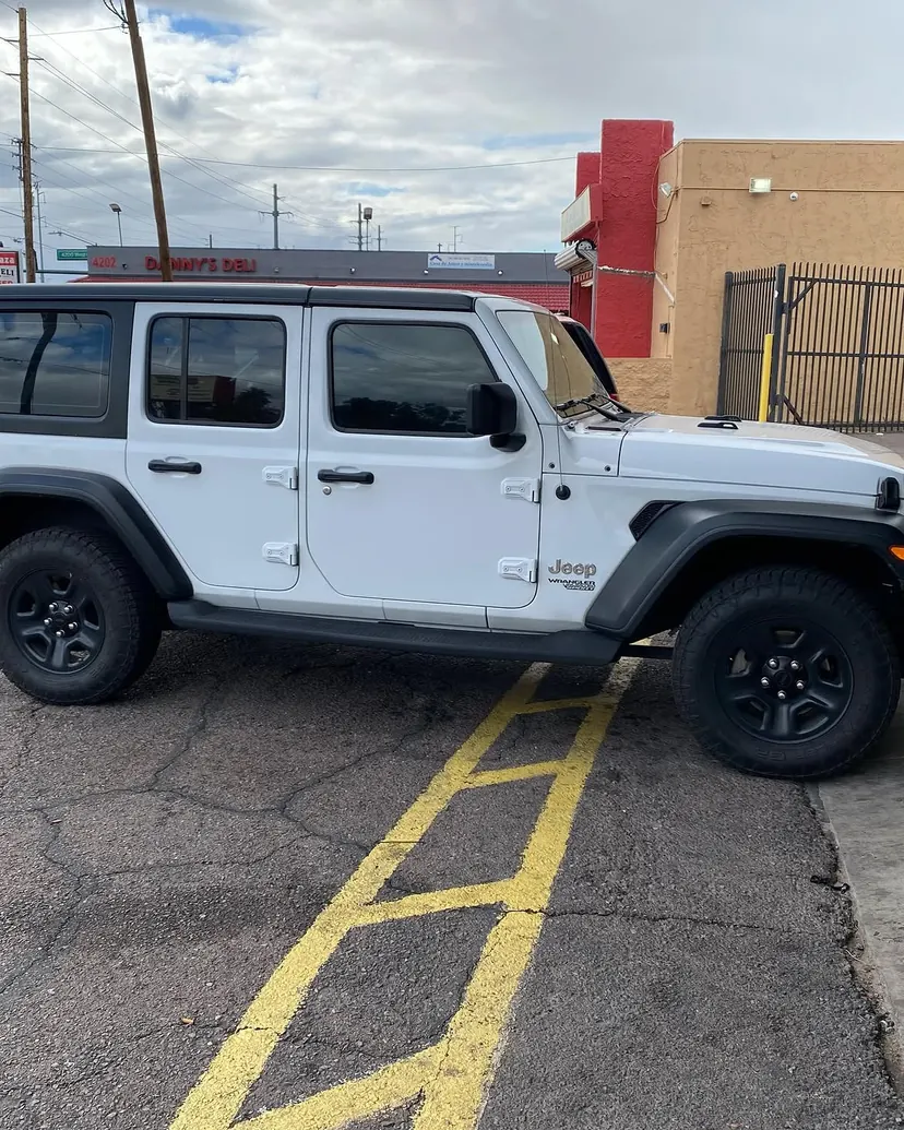 White Jeep Wrangler parked outside Sound Image on Camelback Road in Phoenix